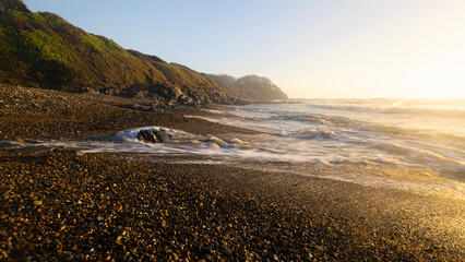 wave on pebbles at rocky beach in Minnie Water NSW Australia