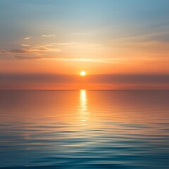 Obraz premium A serene and ethereal seascape is captured during the early moments of a hazy sunrise,with the sun's golden rays gradually breaking through the veil of mist that envelops the horizon. 