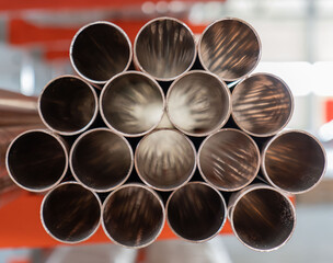 Pipes stack, straight copper. Industrial pieces of pipelines for conduit, factory or construction...