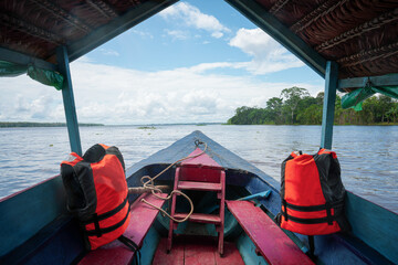 Blue river boat on Amazon River cruise, clear view of Jungle Sky - Iquitos, Peru Stock Photo  