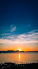 Fototapeta na wymiar Golden sunset at sea. Portrait. Bonbon Beach, Romblon Island, Philippines