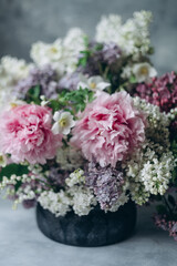 Floral bouquet in lilac shades on a gray background, floristry