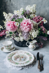Porcelain service and floral bouquet at brunch, gala dinner
