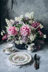 Porcelain service and floral bouquet at brunch, gala dinner
