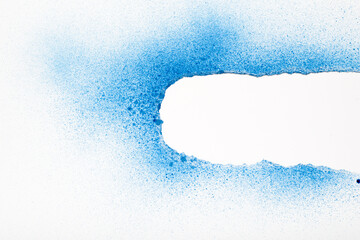 White torn paper painted with blue spray paint revealing white background. Space for text.