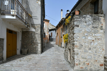A street among the old houses of Macchia Valfortore, a medieval village in Molise, Italy.