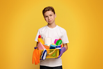 A young boy carrying a basket filled with cleaning supplies.