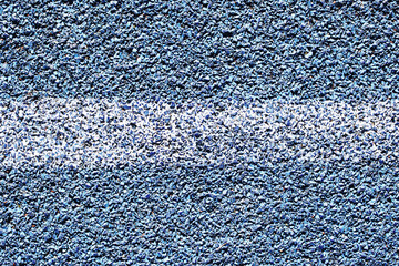 White line sports track background. Paint on blue grain. Articial basketball field closeup line....