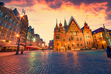 Dramatic summer sunset in Wroclaw Market Square with Town Hall. Picturesque evening view of...