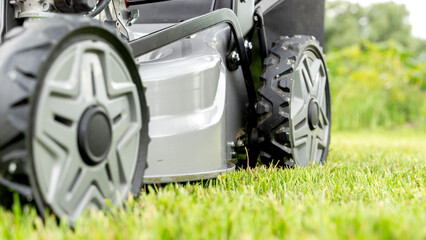 lawn mower on a mowed smooth green lawn