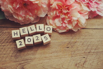 Hello 2025 alphabet letter with space copy on wooden background