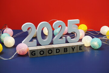Goodbye 2025 word alphabet letters on red and blue background