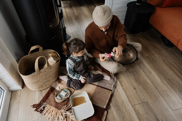 father and daughter spend time together sitting next to each other, share home time, playing on...