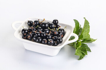 Juicy black currant berries in the bowl