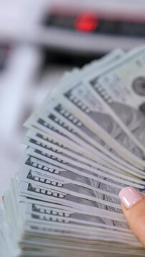 business, finance, saving, banking and people concept - close up of woman hands counting us dollar money Vertical video