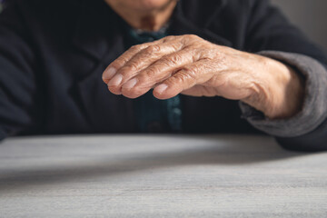 Elderly caucasian woman making protect gesture.