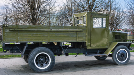 A medium-tonnage truck with a wooden body. The vintage car is made on a frame chassis with springs....