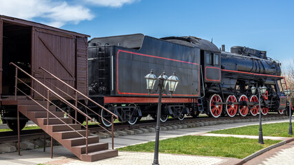 A steam locomotive with a steam power plant using steam engines as an engine. The Soviet mainline passenger steam locomotive. Vintage rail transport. Transportation of goods by rail.