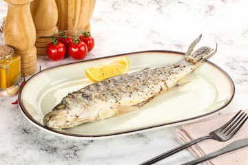 Grilled sea bass fish served lemon