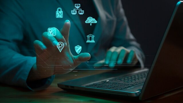 Cg symbols of accumulation and protection of databases against the background of a person working on a laptop with a raised hand on the index finger of which there is a bright light point of AI