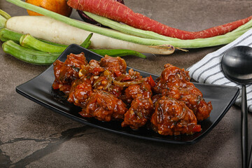 Manchurian chicken with sauce and spices