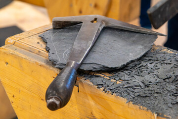 slate with a roofing hammer
