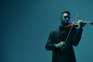 Elegant musician in formal attire playing the violin skillfully against a vibrant blue background