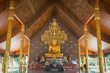 Fototapeta premium The gold Buddha in the Wat Sirindhorn Wararam or Wat Phu Prao, also known as the Glow Temple, is located in Sirindhorn, Ubon Ratchathani, Thailand