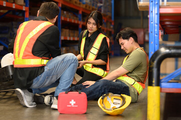 First aid support accident at work of worker at factory. Male worker has an accident on the floor...
