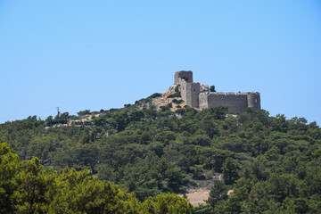 Fototapeta na wymiar Ancient fortress on the island of Rhodes. A beautiful fortress tower from the battle