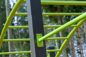 Playground in the park, close-up of green metal structures