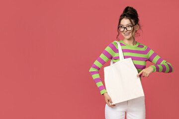 A young girl in glasses with a bag in her hands