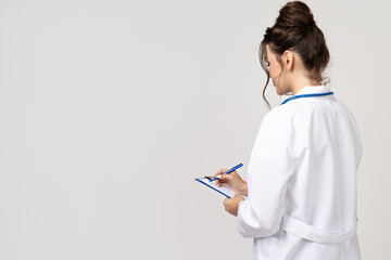 Attractive young girl in a doctor's gown with a stethoscope