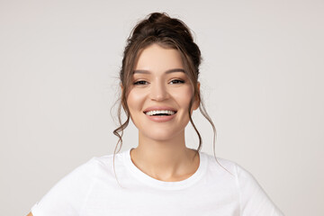 Attractive young girl smiling on a white background