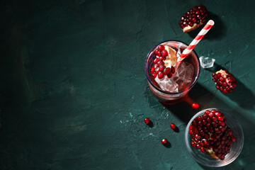 Red cocktail with fresh pomegranate in a glass