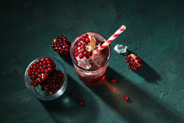 Red cocktail with fresh pomegranate in a glass