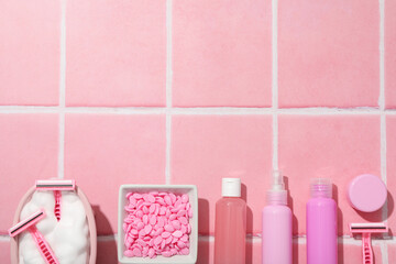 Accessories for depilation on a pink background