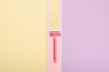 Pink razor for shaving on a beautiful background