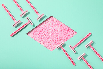 Pink razor for shaving with granules for depilation