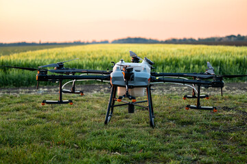 Agriculture drone on the ground ready to take off and spray crops.
