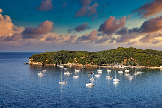 Sunset sky over yachts and sailboats Valtos beach in Parga Greece