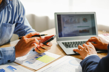 Desk-bound businessman calculates figures, verified accounts, and collaborates in discussions. Proficient in using calculators, aiding each other, and managing annual tax accounts in the audit office