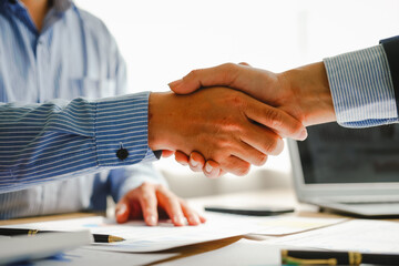 Businessman conducts financial discussions, sealing deals with handshakes. Expert in accounts,...