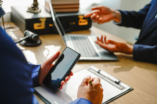 Legal expert navigating corruption cases, including bribery and graft. Businessman consults at desk. Discussions involve bribery, corruption, buying off, and corrupt practices.