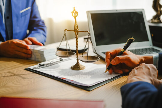 Legal expert navigating corruption cases, including bribery and graft. Businessman consults at desk. Discussions involve bribery, corruption, buying off, and corrupt practices.