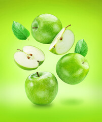 Green apple and green apples slices isolated on green background. File contains clipping path..