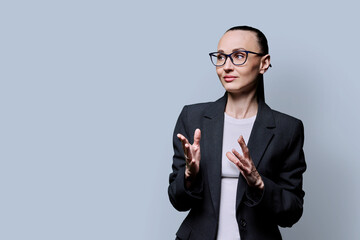 Portrait of thinking serious confident business woman , on grey studio background