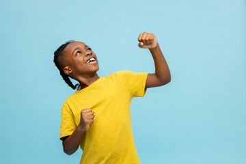 African american boy in yellow shirt looking excited