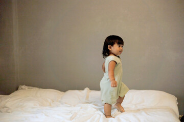 Little Boy Jumping On The Bed