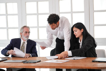 Team of professionals having a meeting in a digital marketing agency. Business people discussing a project in an office. Teamwork and collaboration in a creative workplace.